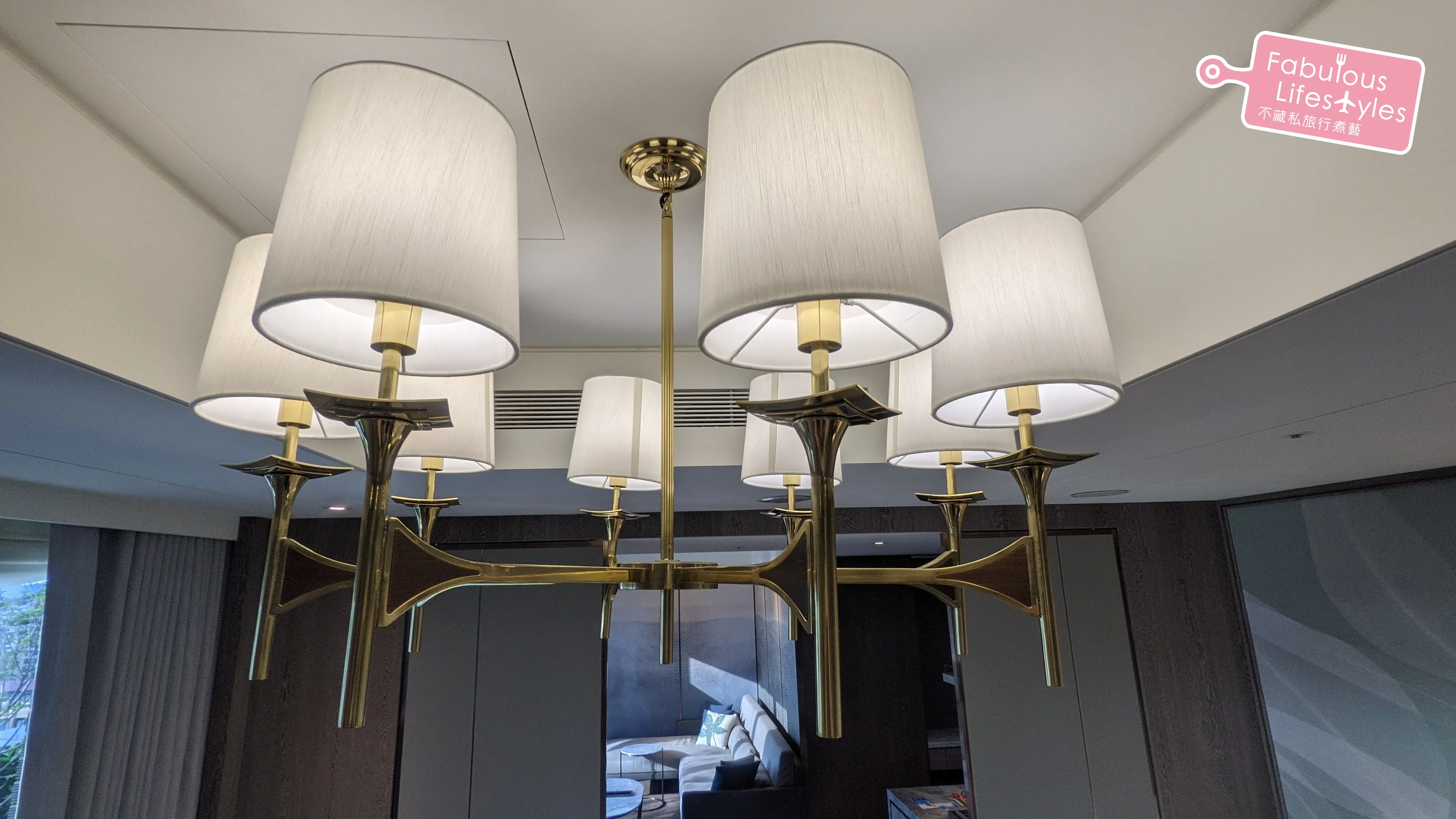 Eight-bulb torch-style chandelier above the bed