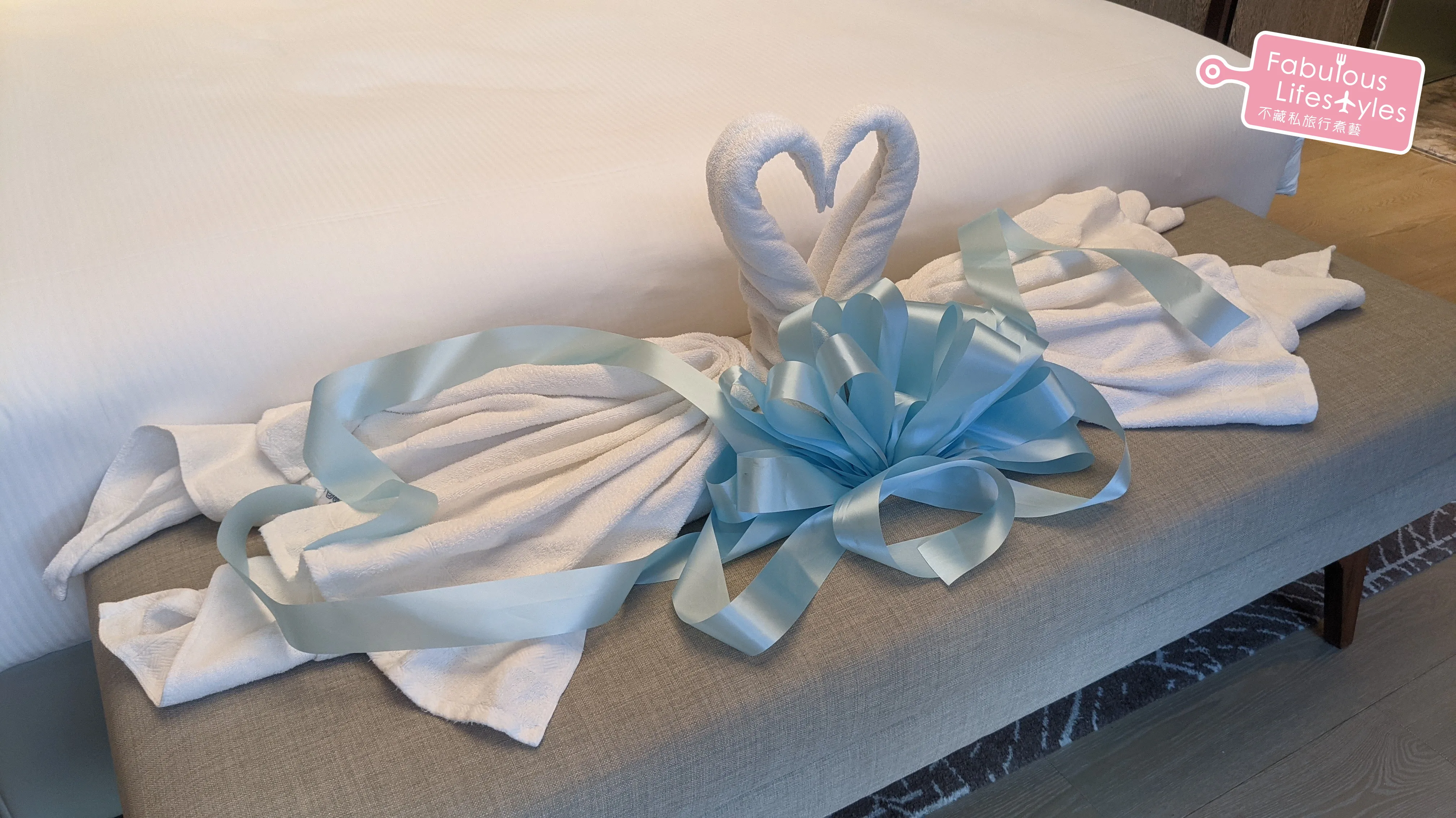 Towel swans relocated to the long sofa bench