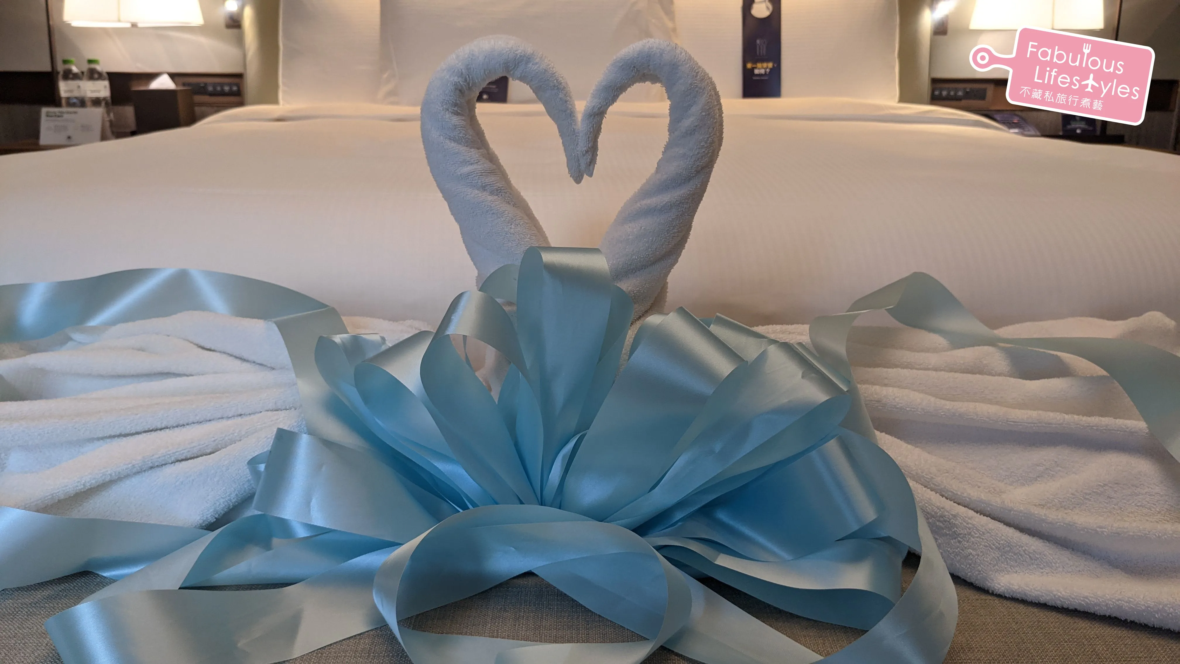 Towel swans relocated to the long sofa bench