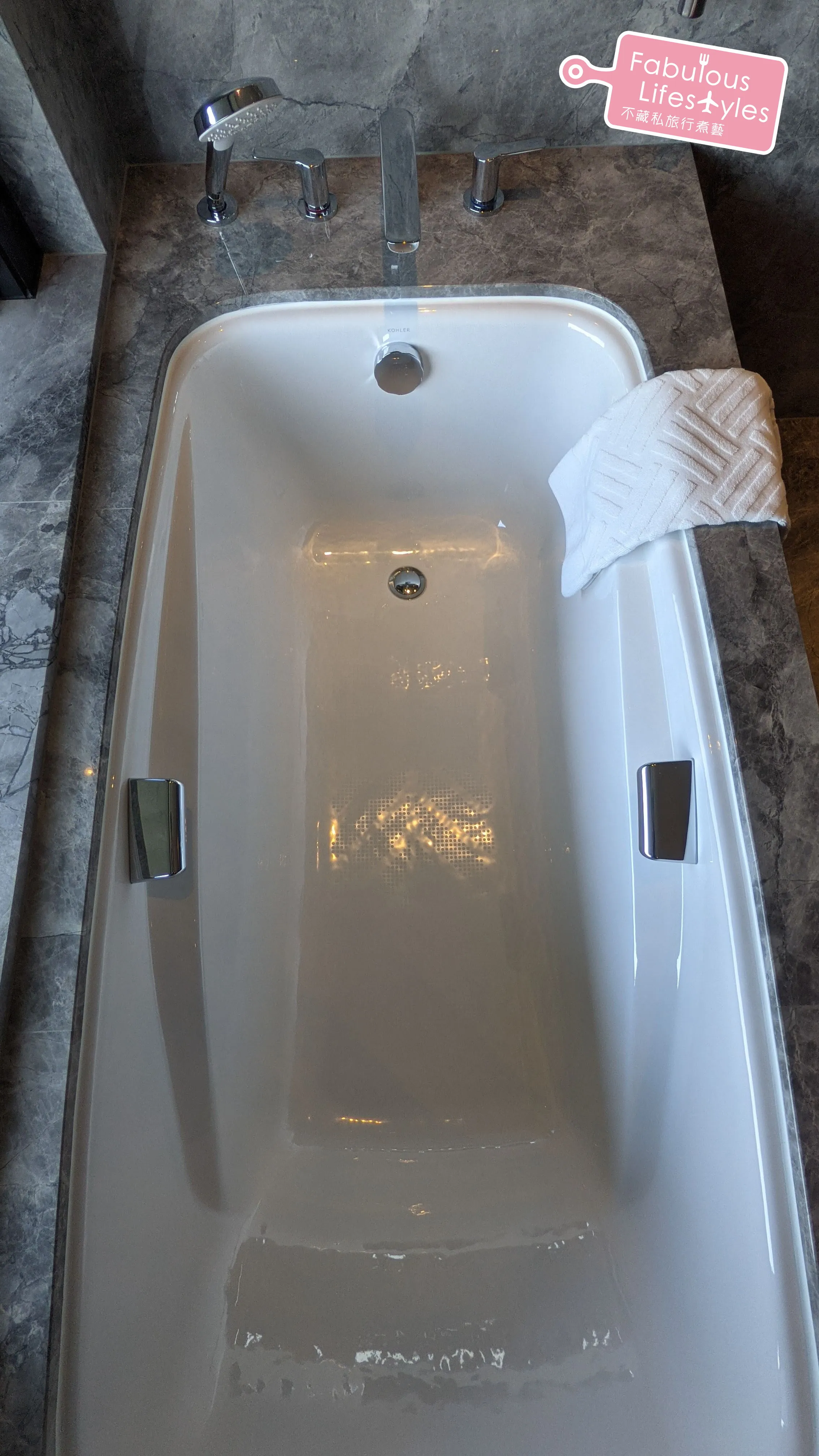 Bathtub with metal grab bars on both sides
